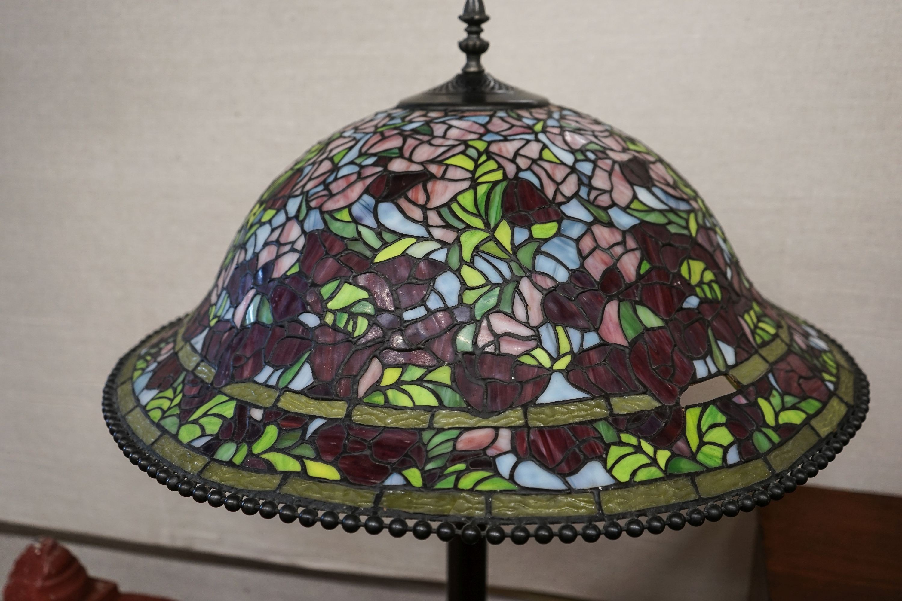 A bronzed finish Tiffany style standard lamp with shade, 160cm high, 59cm diameter